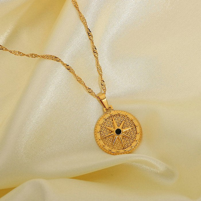 Gold necklace with a intricate pendant on a beige fabric background